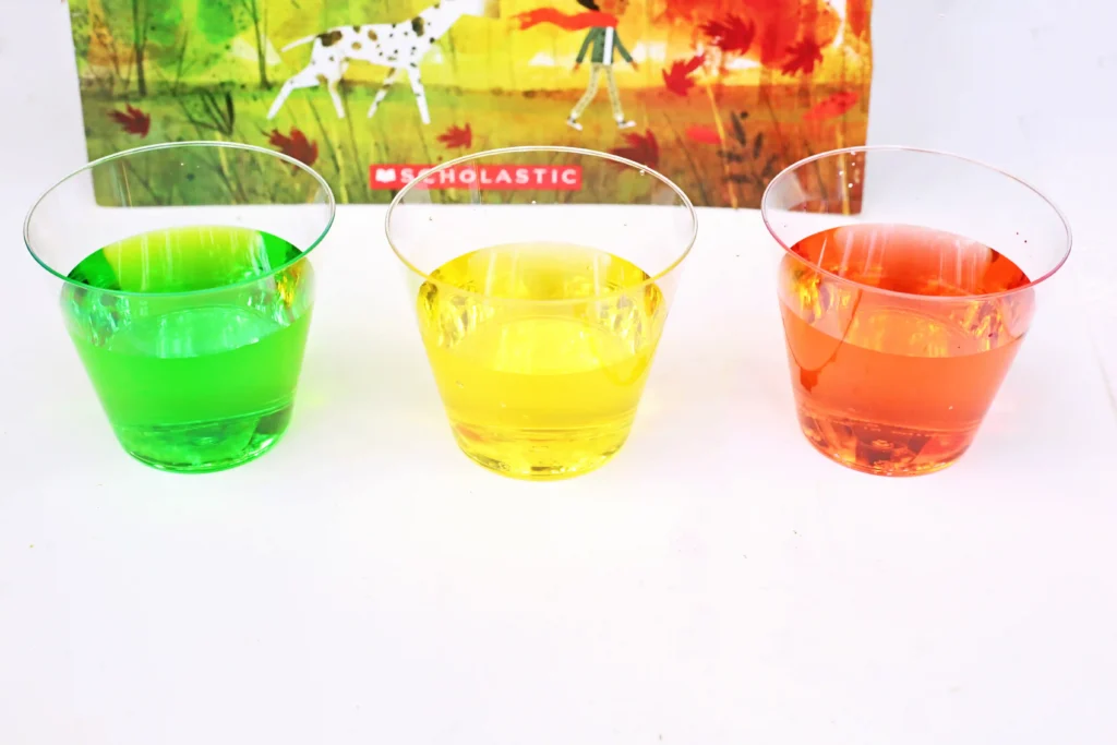 clear cups with red, yellow, and red water