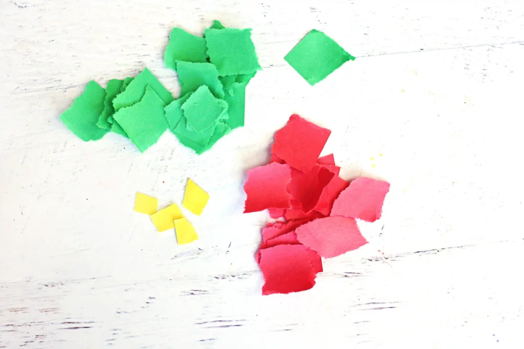 red, green, and yellow construction paper torn into pieces