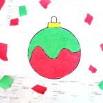 a print out of an ornament with torn construction paper on it